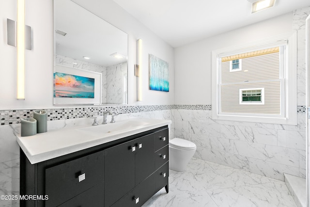 605 Broadway, Barnegat Light, NJ 08006 - bathroom featuring a wainscoted wall, toilet, marble finish floor, tile walls, and vanity