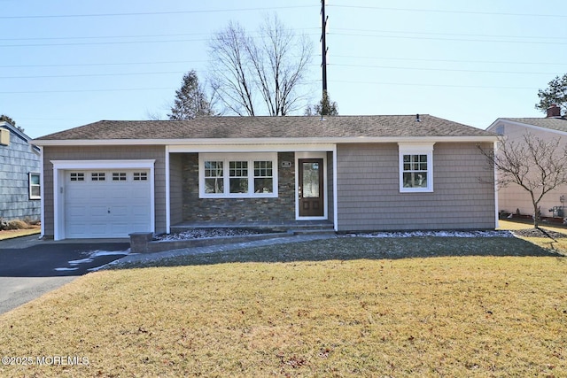 ranch-style house featuring a garage, a shingled roof, a front lawn, and aphalt driveway