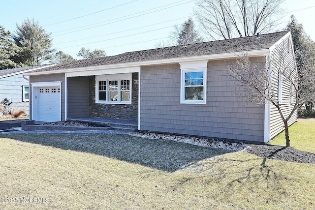 view of front of property featuring a garage, driveway, a front lawn, and a shingled roof