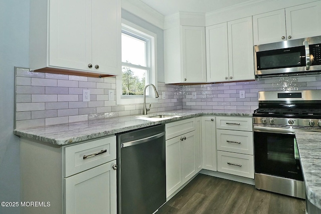 kitchen with light stone countertops, white cabinetry, and stainless steel appliances