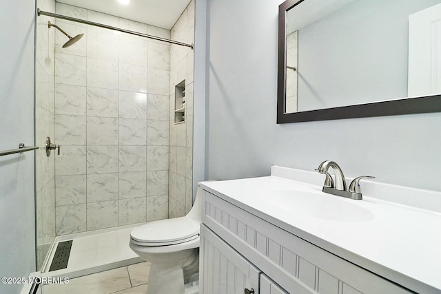 full bathroom featuring a stall shower, vanity, and toilet