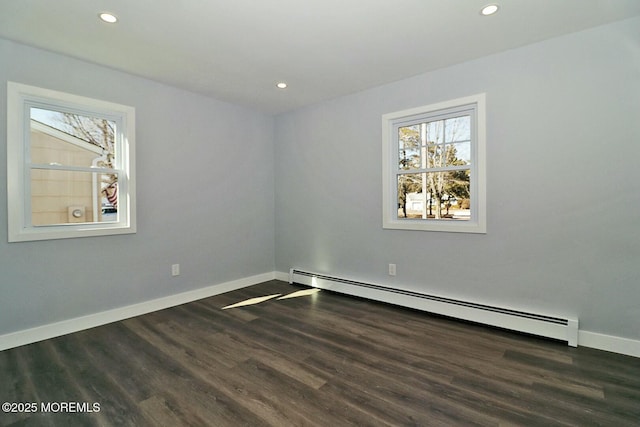 spare room with a baseboard heating unit, dark wood-style flooring, recessed lighting, and baseboards