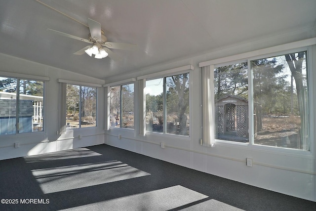 unfurnished sunroom with a wealth of natural light and ceiling fan