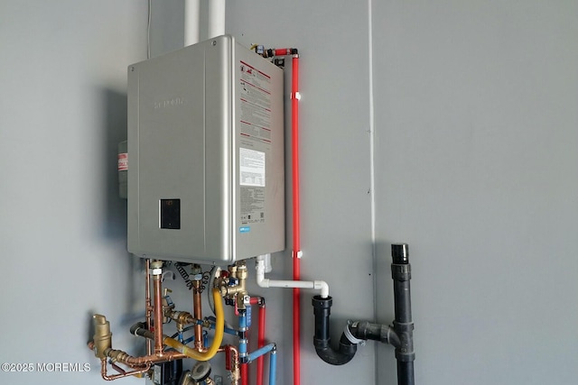 utility room featuring tankless water heater