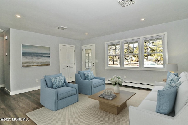 living area featuring a baseboard radiator, visible vents, recessed lighting, and wood finished floors