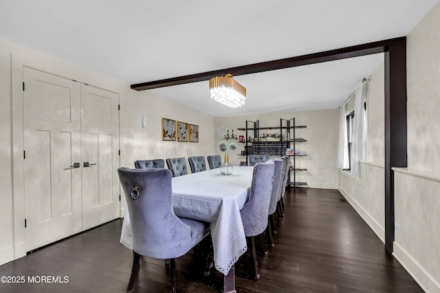 dining space featuring dark wood-style floors, baseboards, a notable chandelier, and beamed ceiling