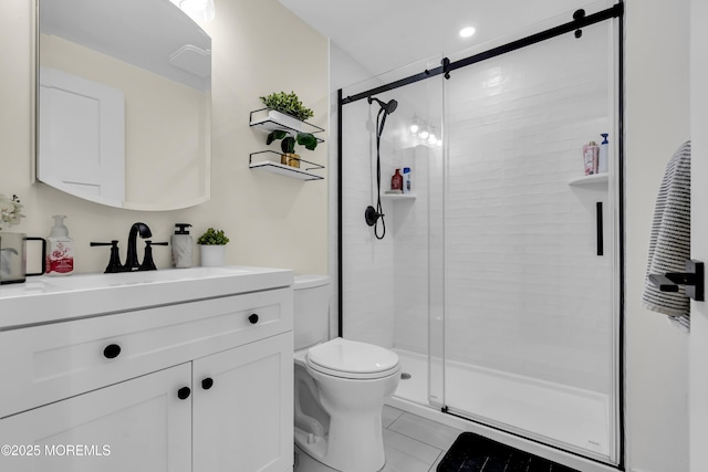 full bath with a stall shower, tile patterned flooring, vanity, and toilet
