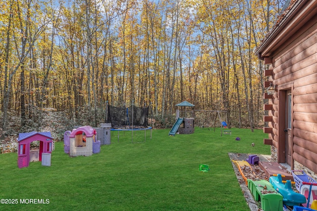 view of yard featuring a trampoline and a playground