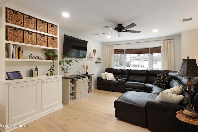 living area featuring ceiling fan, light wood-type flooring, visible vents, and recessed lighting