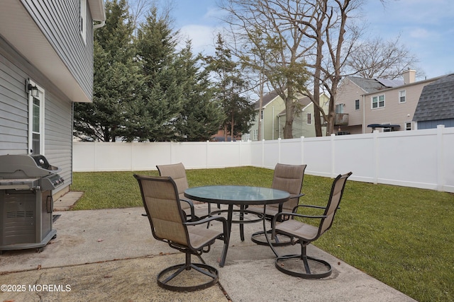 view of patio featuring outdoor dining area, area for grilling, and a fenced backyard