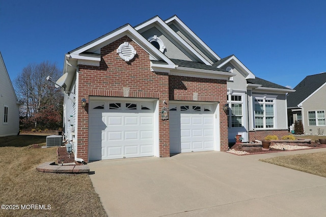 view of front of property with driveway, an attached garage, central AC, and brick siding