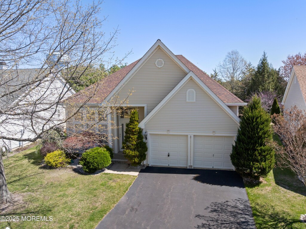 12 Fish Pond Ter, Barnegat, NJ 08005 - traditional-style home with an attached garage, driveway, and a front yard