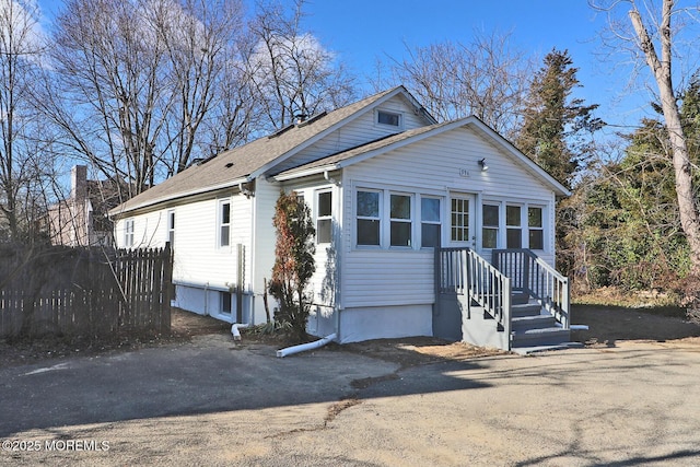 view of front of house featuring fence