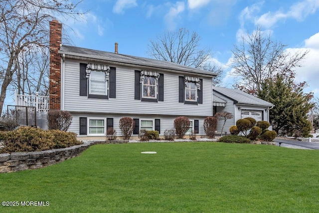 view of front of home featuring a garage, a chimney, and a front yard