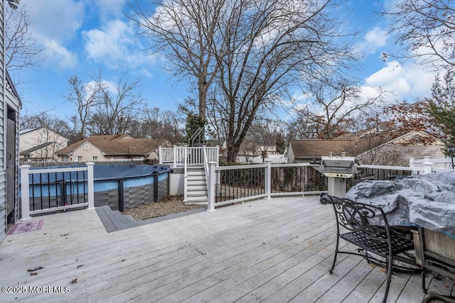 wooden terrace with a covered pool