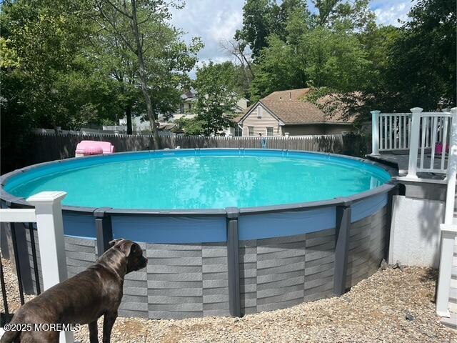 view of swimming pool featuring fence and a fenced in pool