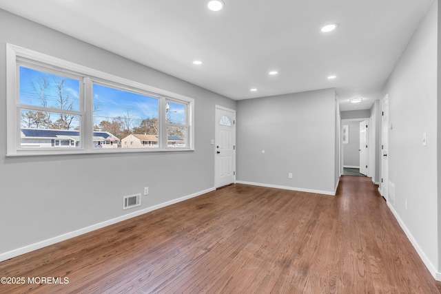 interior space featuring recessed lighting, visible vents, baseboards, and wood finished floors