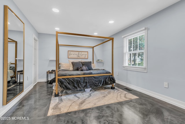 bedroom featuring baseboards, concrete floors, and visible vents