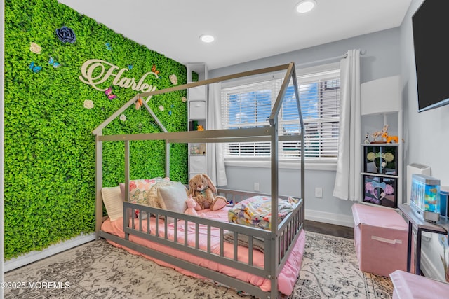 bedroom with baseboards, wood finished floors, and recessed lighting