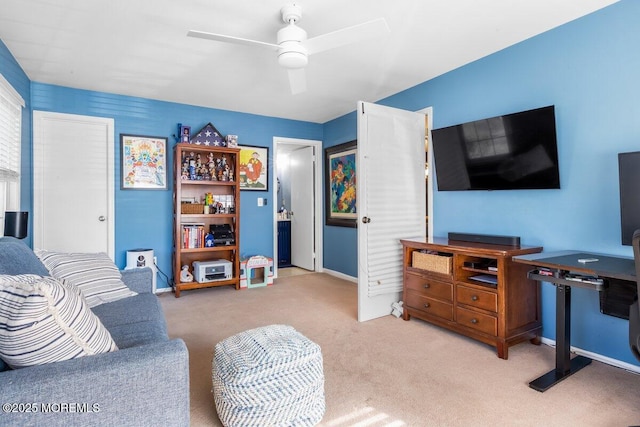 living area with light carpet, ceiling fan, and baseboards