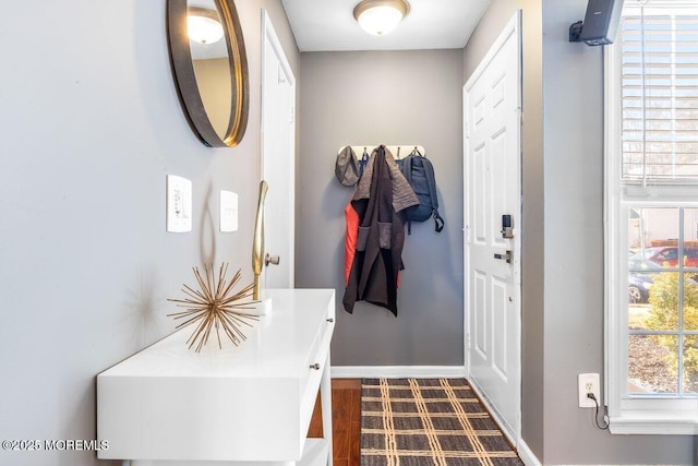 foyer entrance featuring baseboards