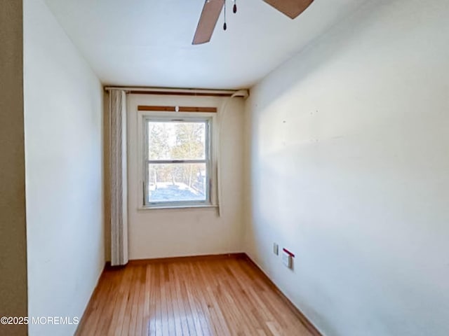 spare room with light wood-type flooring and ceiling fan