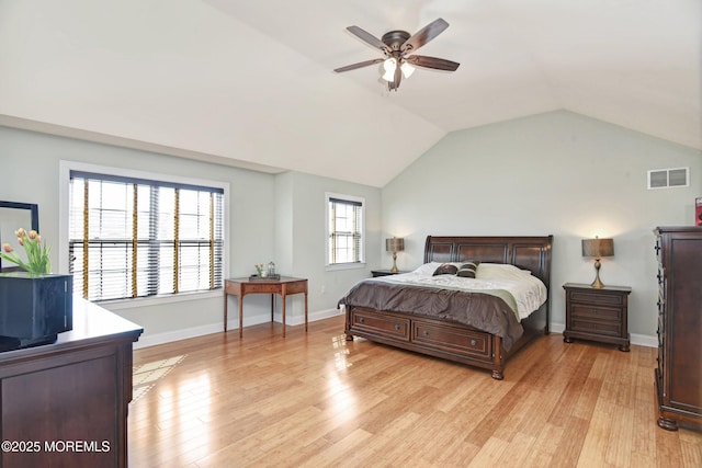 bedroom featuring baseboards, visible vents, lofted ceiling, ceiling fan, and light wood-style floors