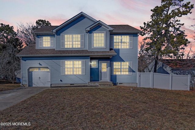 traditional-style house with driveway, crawl space, an attached garage, fence, and a front yard