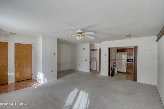 unfurnished living room featuring ceiling fan and light colored carpet