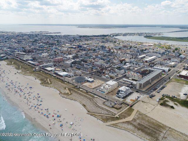 birds eye view of property featuring a view of city, a beach view, and a water view