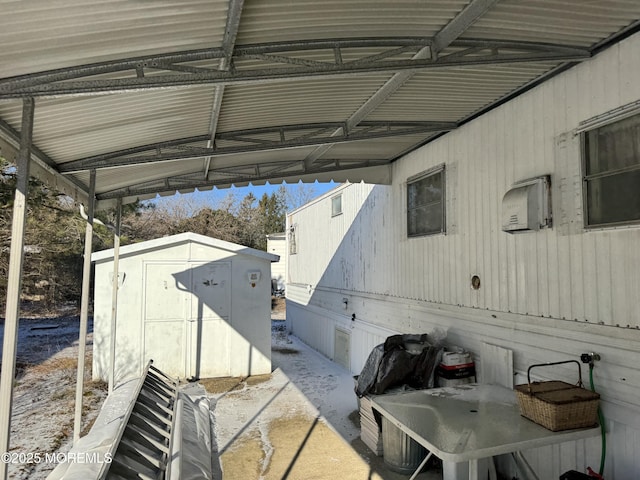 view of patio / terrace featuring an outbuilding and a storage unit