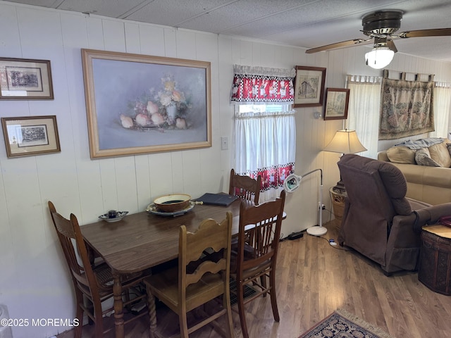 dining room featuring a ceiling fan and wood finished floors