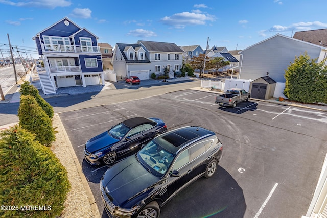 uncovered parking lot featuring a residential view