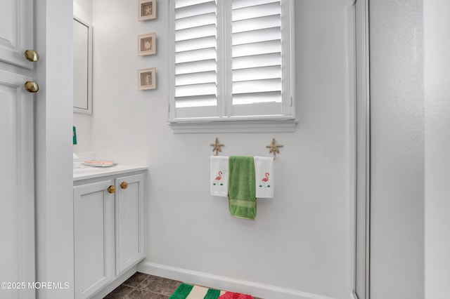 bathroom with baseboards and vanity