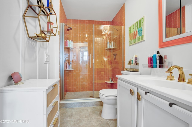 bathroom with vanity, tile patterned flooring, a shower stall, and toilet