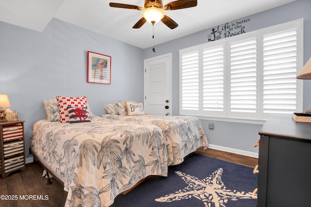 bedroom featuring wood finished floors, a ceiling fan, and baseboards