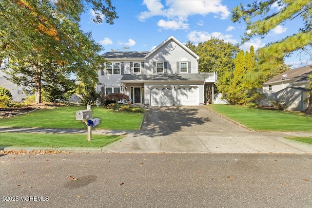 view of front of home featuring a front yard, driveway, and an attached garage