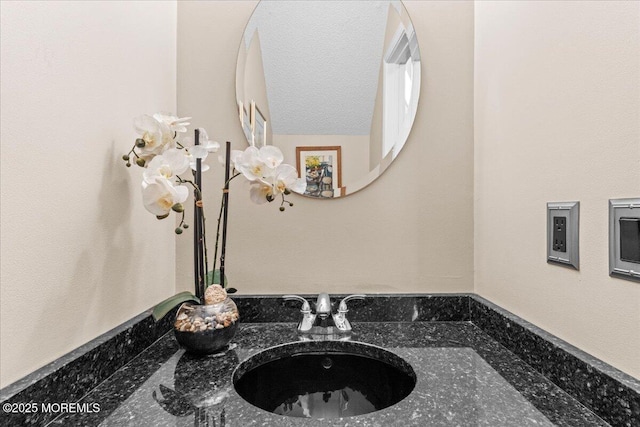 bathroom featuring a textured ceiling and vanity