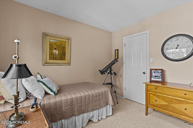 bedroom featuring light carpet and a textured ceiling