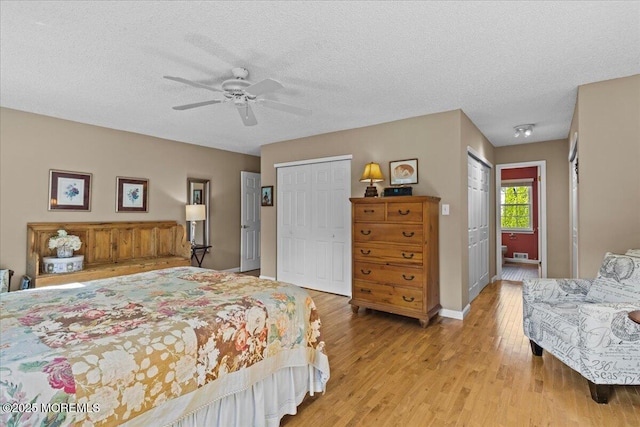 bedroom with light wood finished floors, a ceiling fan, baseboards, and a textured ceiling