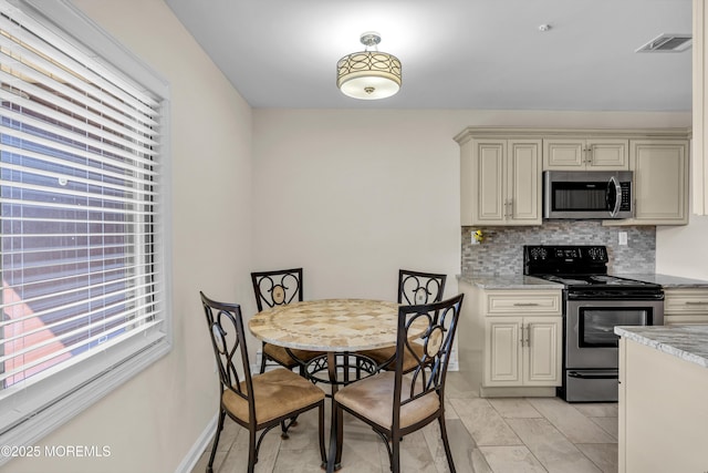 dining space featuring visible vents and plenty of natural light