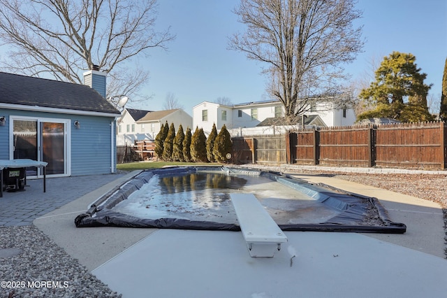 view of pool with a fenced in pool, a residential view, a patio area, and a fenced backyard