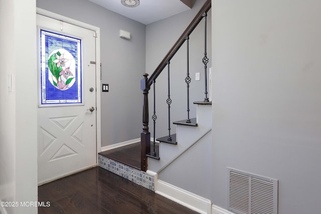 entrance foyer with stairway, dark wood-style flooring, visible vents, and baseboards