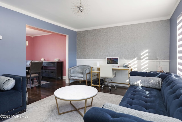 living area with ornamental molding, a wainscoted wall, dark wood-type flooring, and wallpapered walls