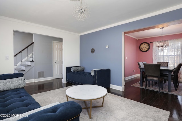 living room featuring baseboards, visible vents, stairway, dark wood-style flooring, and a notable chandelier