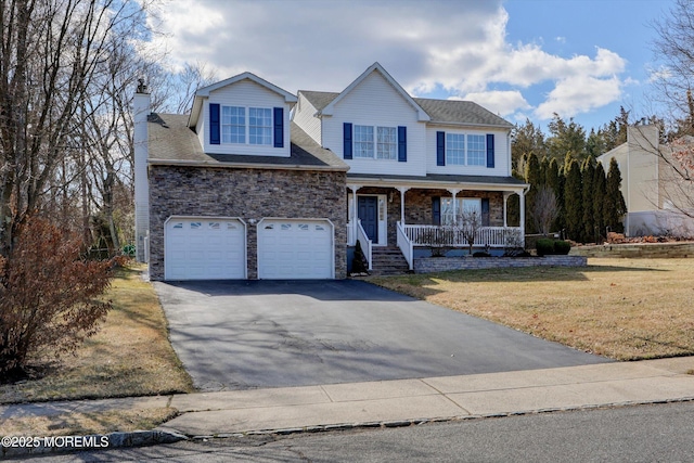 view of front of property with aphalt driveway, a chimney, covered porch, stone siding, and a front lawn