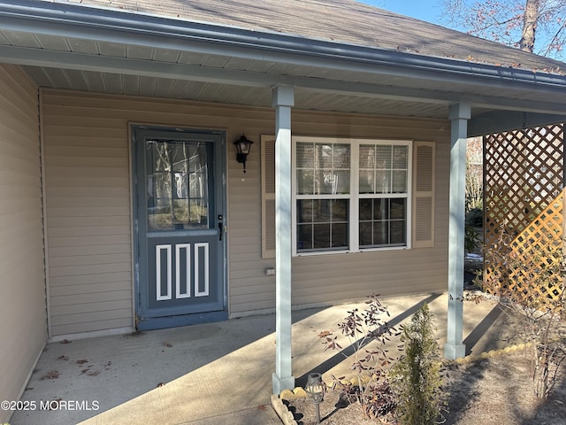 property entrance with a shingled roof