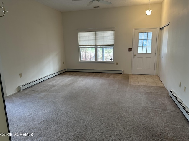 interior space with a baseboard heating unit, a baseboard radiator, light colored carpet, and ceiling fan