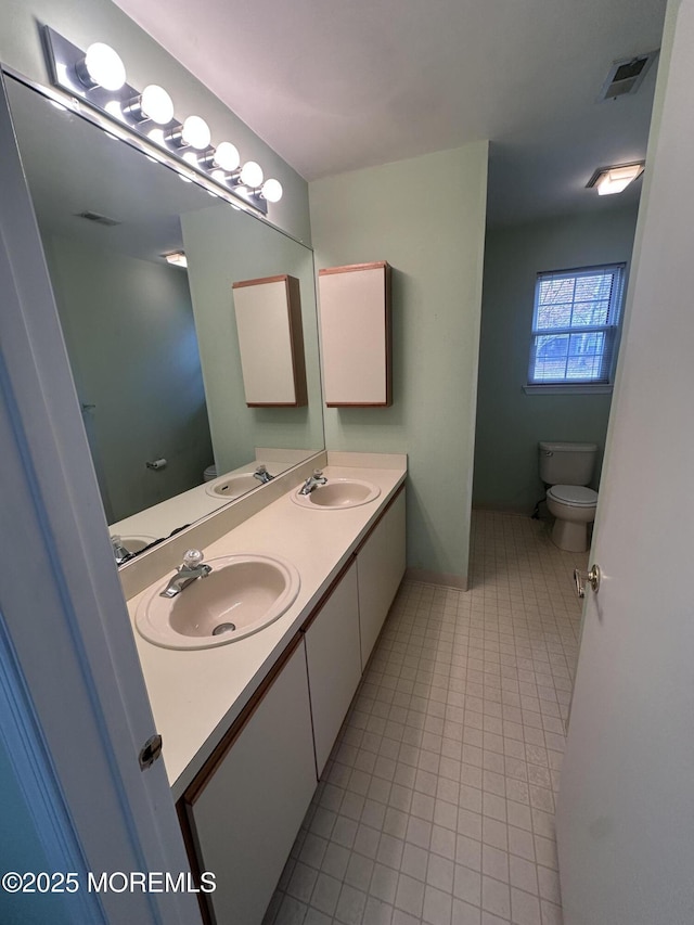 full bath with visible vents, a sink, and double vanity