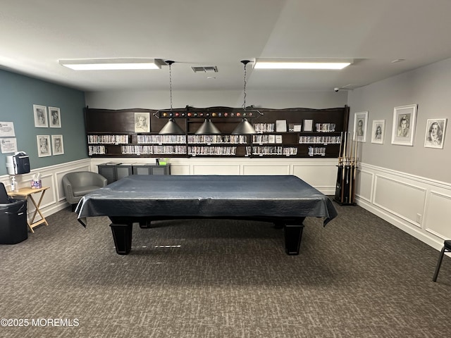 playroom featuring wainscoting, visible vents, dark colored carpet, and a decorative wall